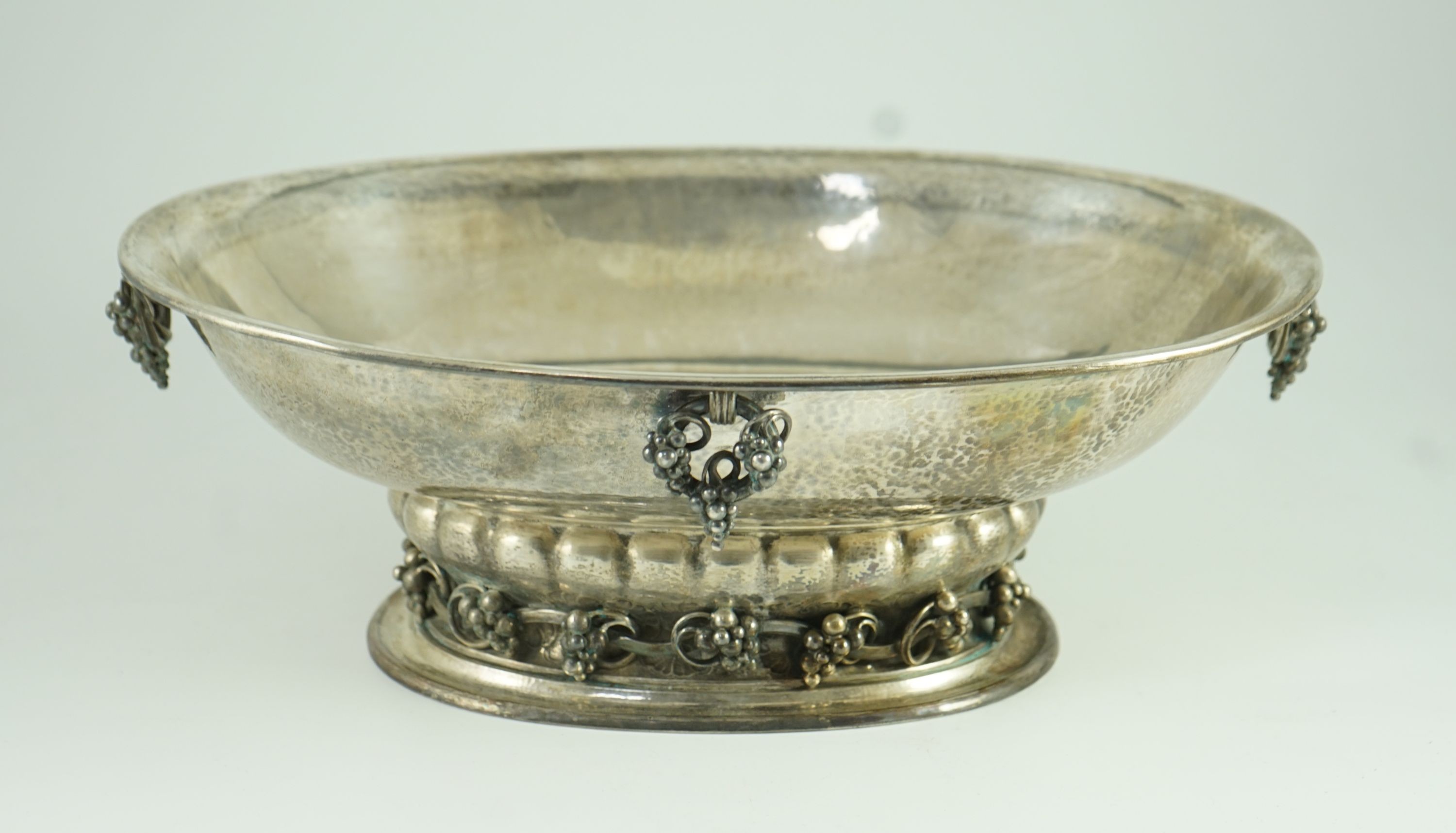 A good George V Georg Jensen planished silver Grape pattern oval pedestal fruit bowl, design no. 296